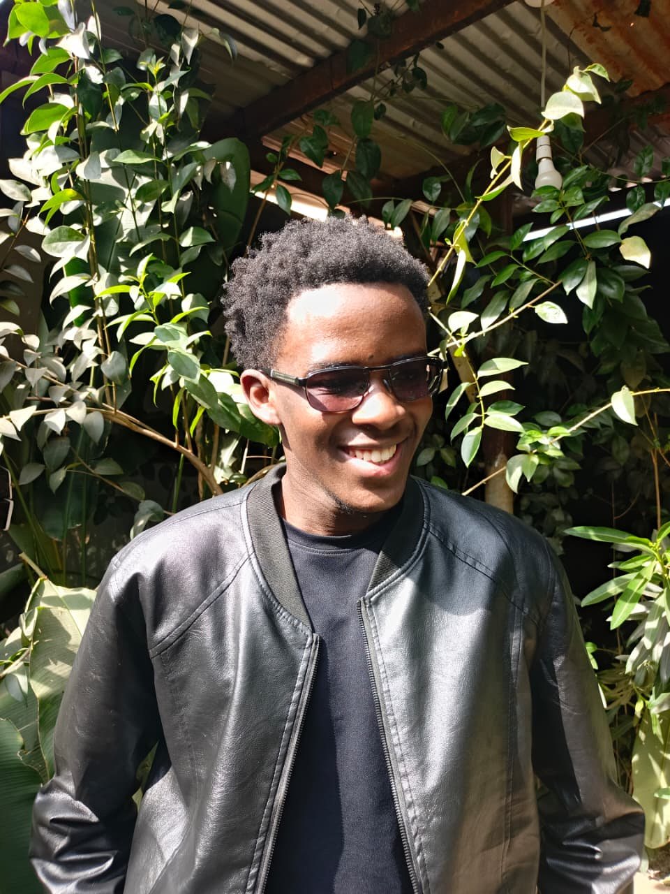 Zull Wankio, developer, smiling outdoors in a black jacket